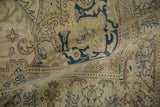Folded detail showing the distressed texture and low pile of a vintage Kayseri carpet.