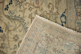 Flipped corner of a distressed Kayseri carpet reveals its hand-knotted foundation and low pile.