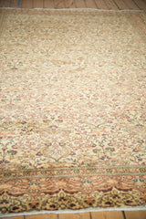 Dense floral pattern of the vintage Turkish Kayseri rug in cream, aubergine, and orange.
