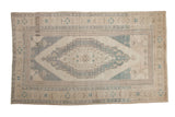 Distressed vintage Oushak carpet with a stepped concentric medallion in soft slate blue and sand.