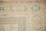 Mostly even wear to knot heads on a distressed Oushak, showing slate blue and sand details.