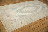 Evenly worn pile and intact side cord of a distressed vintage Turkish Oushak carpet.