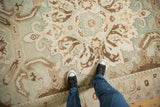 Overhead view of the low-pile texture and scrolled Rococo-style patterns on a distressed vintage Sparta carpet.
