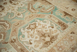 Evenly worn, low pile on a vintage Sparta carpet showing scrolled motifs in sand and ivory.