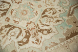 Softly worn pile on a vintage Sparta carpet with brown and pale blue Rococo-style designs.