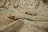 A fold in the vintage Sparta carpet reveals its tightly knotted weave and low, textured pile.