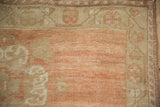 Distressed texture and abrashed pale cantaloupe field with beige meandering vine border.