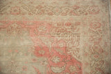 Distressed vintage Turkish Kayseri rug showing textured pile with faded pink and beige patterns.
