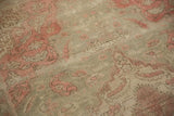 Distressed Kayseri rug's time-softened pile texture in muted pink and sage.