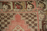 Vintage Oushak rug detail with stepped spandrel and blush, beige lattice blossom design.