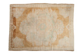 Distressed Turkish Kars carpet with a faded oversized medallion in platinum, copper bronze, and seafoam.