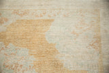 Pale copper bronze and seafoam green motifs on the low-pile texture of a distressed vintage Kars carpet.
