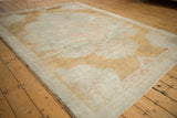 Abrashed ground of a distressed Kars carpet with pale copper and seafoam green tones.