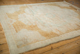 Angled view across the distressed Kars carpet's time-worn texture and soft patina.