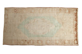 Vintage distressed Oushak carpet, cream field, faded green-blue medallion, rust borders, 4'10