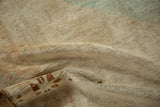 Close-up of the distressed vintage Oushak rug pile, featuring time-softened beige and brown hues.