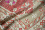 Evenly worn, low pile on a distressed Oushak runner in dusty raspberry red and antique ivory.