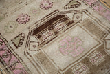 Evenly worn pile on a geometric medallion with chocolate brown and bubble gum pink details.
