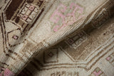 Textured low pile and intact side cord selvage on a distressed vintage Kurd rug runner.