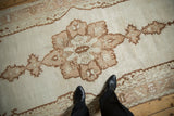 Close view of the starburst medallion's low pile texture in pale coffee and chocolate brown.