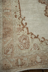 Visible knot heads and a serrated leaf border on a distressed Oushak rug runner.