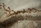 Softly draped vintage Oushak rug showing its distressed low pile and knot heads.