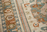 Distressed texture and muted peach, blue, brown geometric motifs on a vintage Taspinar rug.