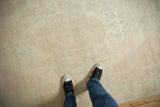 A vintage distressed Oushak rug with a soft, low pile and mostly even wear.