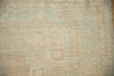 Mostly even wear to the knot heads on a distressed Oushak rug in sand and seafoam green.