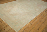 Time-softened pile of a vintage Oushak rug in muted sand and seafoam tones.