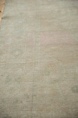 Mostly even wear across the knot heads on a distressed vintage Oushak rug runner.