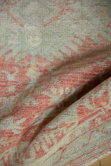 Soft, pliable texture and even wear on a hand-knotted vintage Oushak rug.