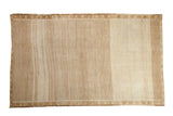Vintage Kars carpet with a distressed diamond lattice pattern and soft, tonal variations in sand and ivory.