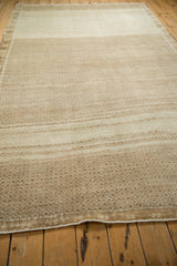 Angled view showing the dynamic abrash from sand to ivory across the geometric field of a Kars carpet.