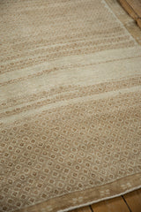 Angled view of the geometric lattice pattern and short pile texture on a distressed Kars carpet.