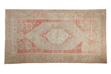 Vintage distressed Oushak rug in rose and sand, with a stepped medallion and pictorial village border.