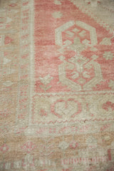 Distressed wool pile showing the stepped design in dusty rose and ivory.