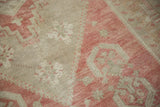 Distressed hand-knotted pile showing heavy abrashes and even wear across the rug's knot heads.