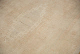 Even wear across the knot heads and low pile texture of a distressed vintage Oushak rug.