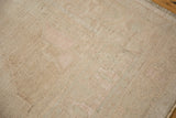 Even wear across the knot heads of a distressed Oushak rug, revealing its soft, sandy texture.