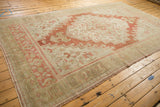 Distressed Oushak rug: worn side selvage, fringe, muted rust, beige, and olive tones.