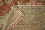 Hand-knotted vintage distressed Oushak carpet showing mostly even wear, fringe, and woven reverse.