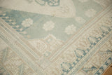 Vintage distressed Oushak hand knotted rug, showing pale blue and cream geometric and floral patterns.