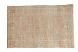 Vintage distressed Anatolian rug with triple diamond medallions in a pale blush, coral, and ivory palette.