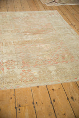 Low pile and visible knot heads on a distressed Anatolian rug with muted coral tones.