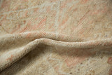 A soft fold showing the hand-knotted texture and distressed pile of a vintage Anatolian rug.