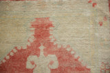 Close-up of the distressed Oushak rug's texture showing mostly even wear to the knot heads.