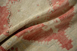 Detailed texture of a distressed Oushak rug, with a low pile worn evenly to the knot heads.