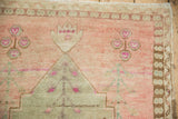 Distressed Oushak rug: primitive magenta blossoms, dusty rose abrash field, and narrow border detail.