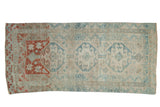 Distressed Anatolian rug with three blue geometric medallions and a striking terracotta red dye lot change.